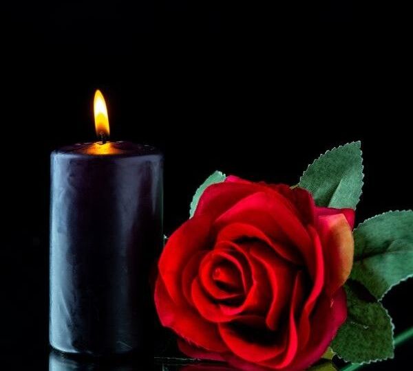 front-view-dark-candle-with-red-rose-dark-surface